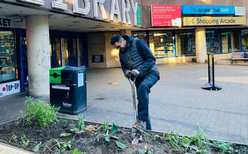 Newcombe gardening outside a library in Haringey