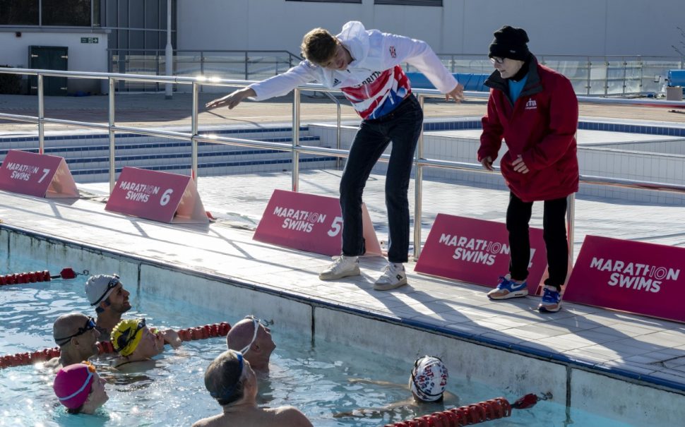 Hector Pardoe teaches some swimmers who are in the pool