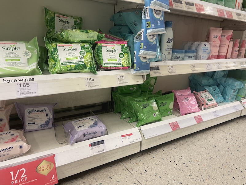 wet wipes stacked on shelves in a supermarket.