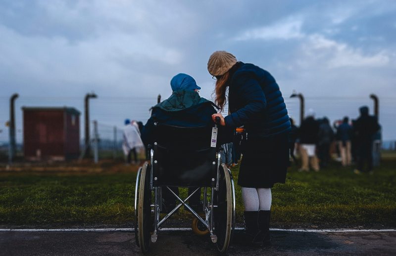 Someone leaning into another person in a wheelchair