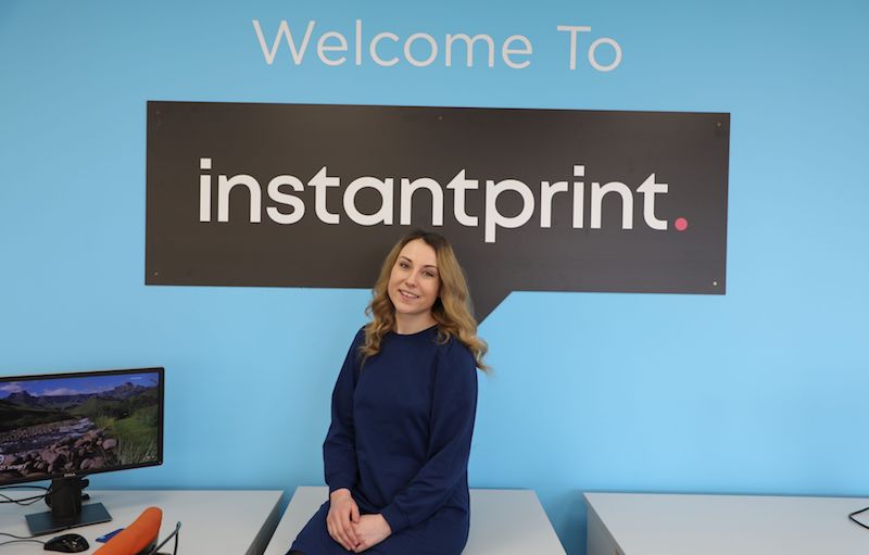 Head of Instantprint Laura Mucklow with a banner