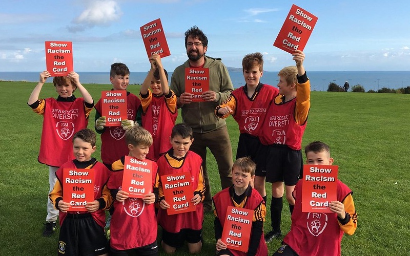 Kids holding up pamplets for Show Racism the Red Card