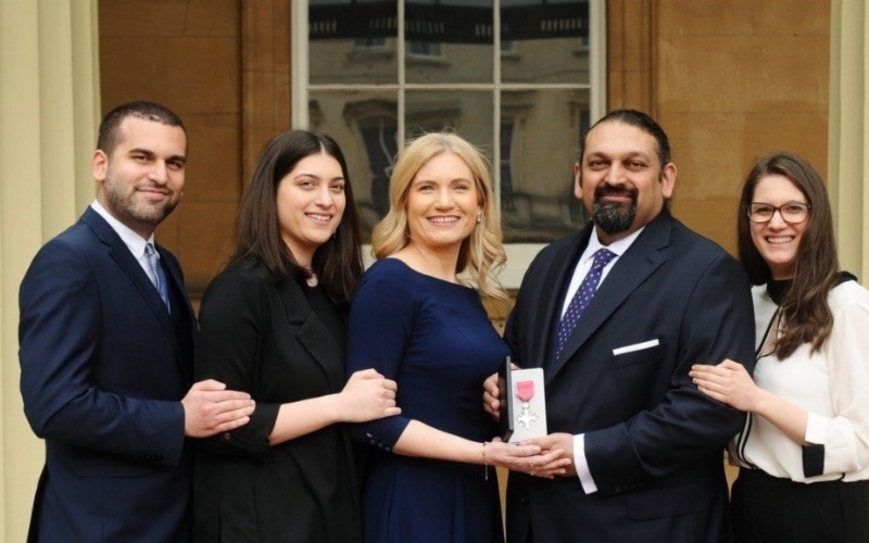 Shajjad Rizve MBE and family outside Buckingham Palace