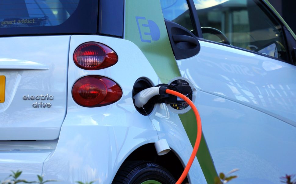 An electric vehicle, plugged in to charge