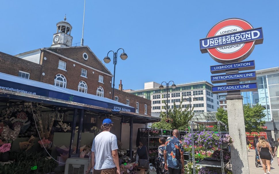 Flower stall and underground sign outside Uxbridge station