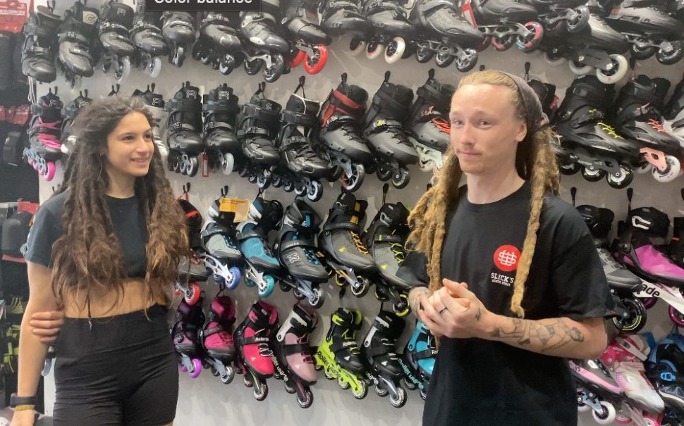 Here you can see the two staff members of the store in front of a wall of roller-skates