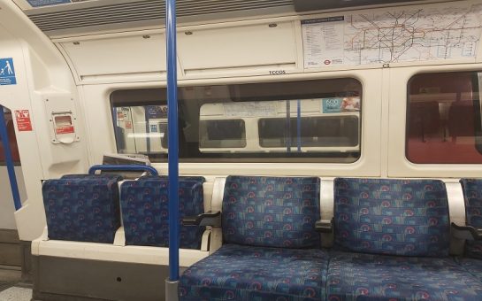 A photo of a empty tube car at night
