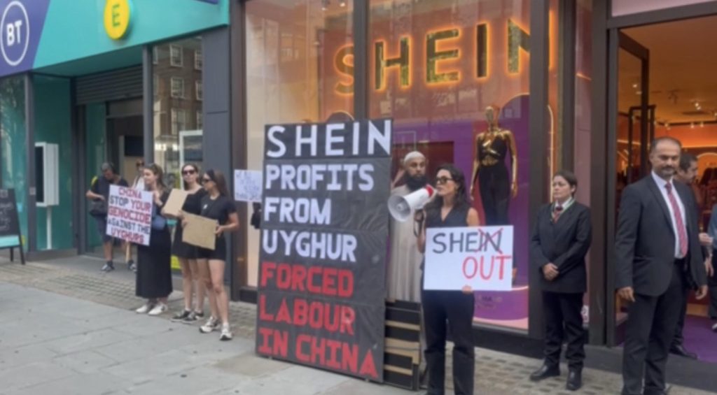 Protestors stood outside Shein's London pop up shop in Oxford street holding placards.