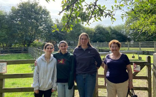 A photo of three volunteers and the farm manager on a sunny day at Freightliner's Farm in Islington