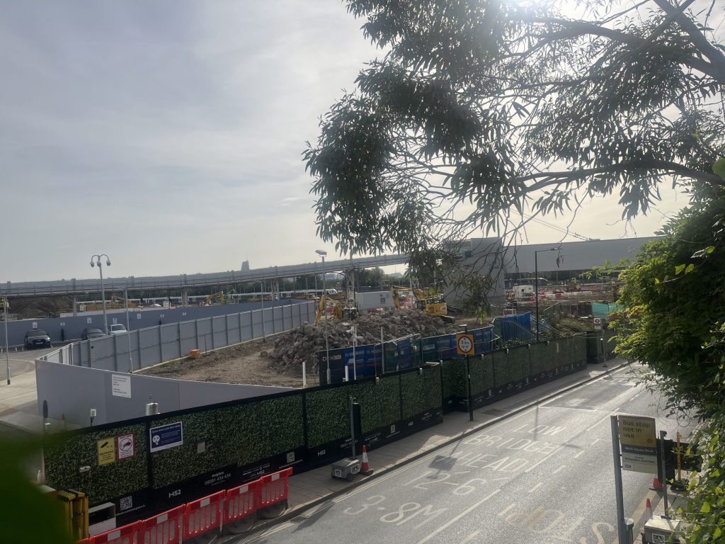 HS2 construction site in Old Oak Common. Large temporary wall hides the major construction works.