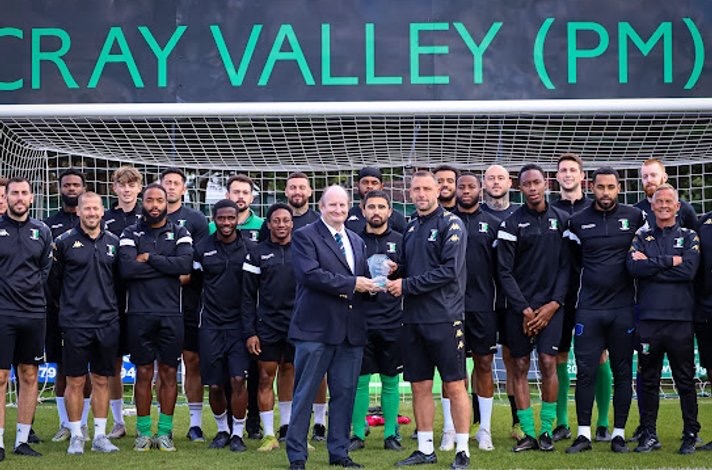 Steve McKimm receiving the Isthmian South East Manager of the Month award for August  in front of players and staff.