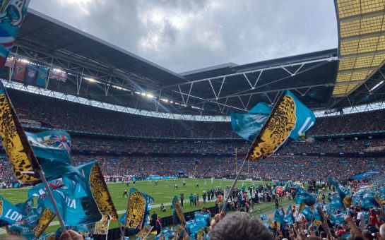 Five Jacksonville jaguars flags being flown at Wembley arena. The flags are light blue with an image of a jaguar on them.