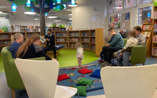 A photo of storytime to children at Uxbridge Library for International Men's Day