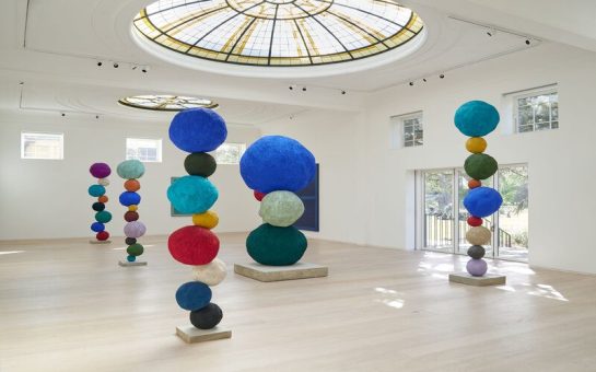 Colourful spheres stacked on top of each other in an art gallery