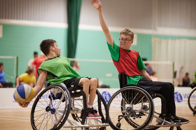 A young wheelchair basketball player prepares to shoot over another at the 2023 WheelPower National Junior Games
