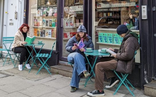 Customers sit outside Bookbar in Islington