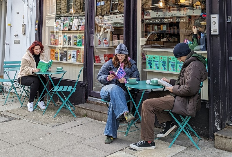 Customers sit outside Bookbar in Islington