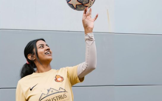 Girl in football kit looking up