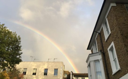 Photograph of Islington with a rainbow over buildings.