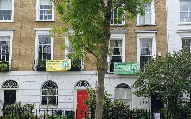 Houses along Liverpool Road displaying signs from the Save Lungs on Liverpool Road campaign.