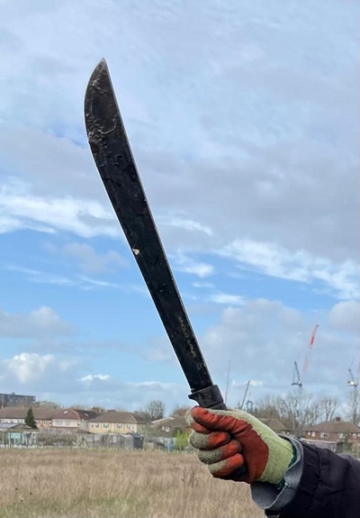 A photo of a machete found in the Ealing canal, held up by one of the volunteers.
