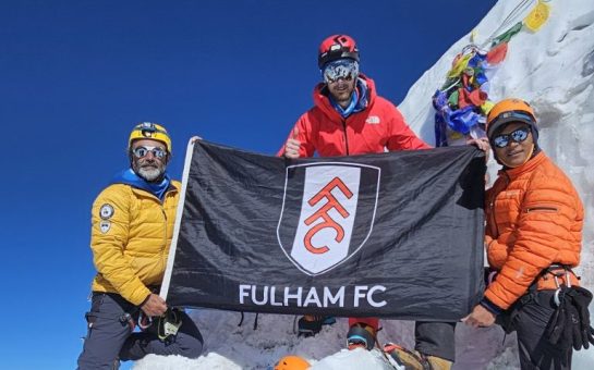 The crew with a Fulham FC banner