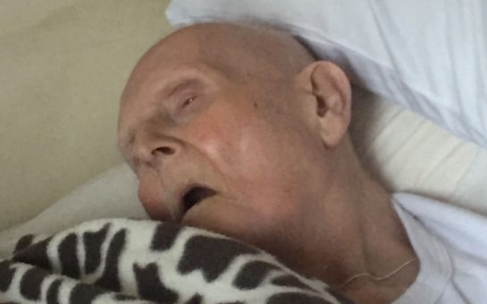 Grandfather in a care home bed