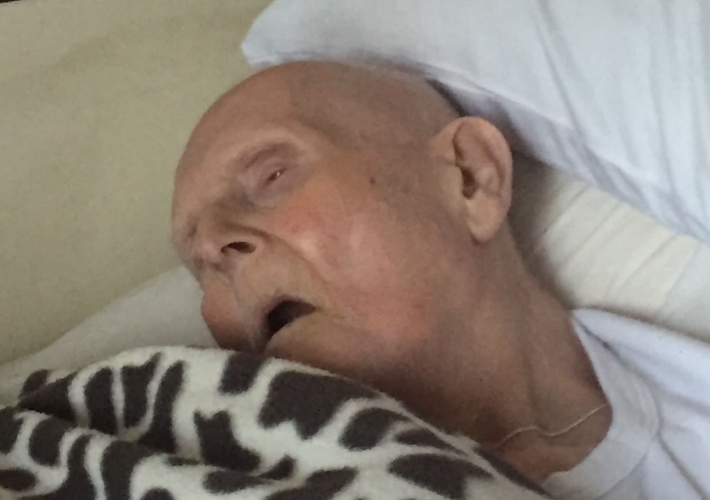 Grandfather in a care home bed