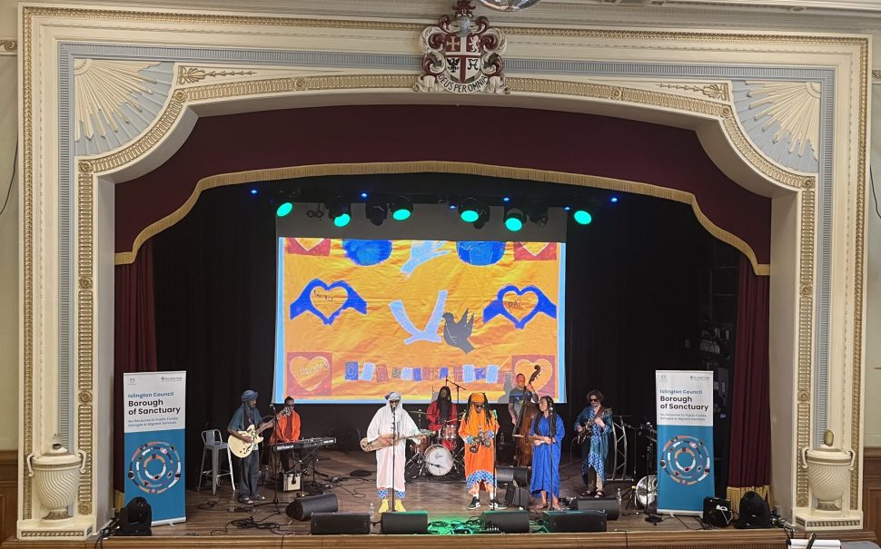 Arfoud Brothers and Sisters band performing on stage at Refugee Week event.