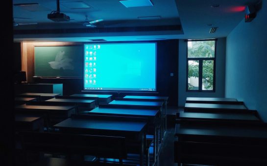 A classroom with a projector screen