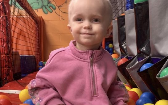 Toddler at the center of the fundraiser Lucy playing in a ball pit