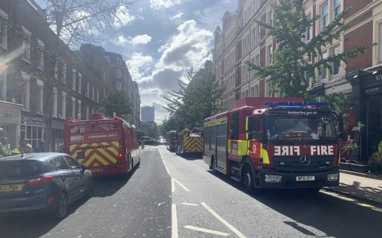 Fire trucks on either side of the road responding to the burst water main