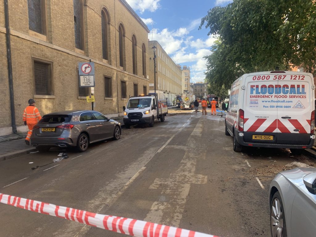 Flood Response and Thames Water crews respond to the flood on Enford Street