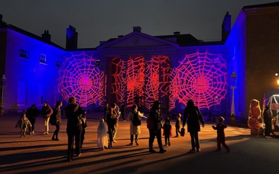 Kenwood House at Halloween event with red cobwebs projected onto the wall