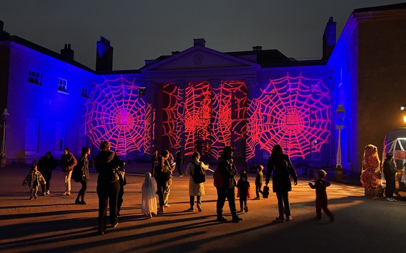 Kenwood House at Halloween event with red cobwebs projected onto the wall