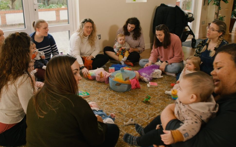 Mums sit in circle with their babies