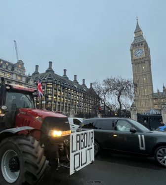 A tractor with the phrase "Labour out" is driven by Westminster