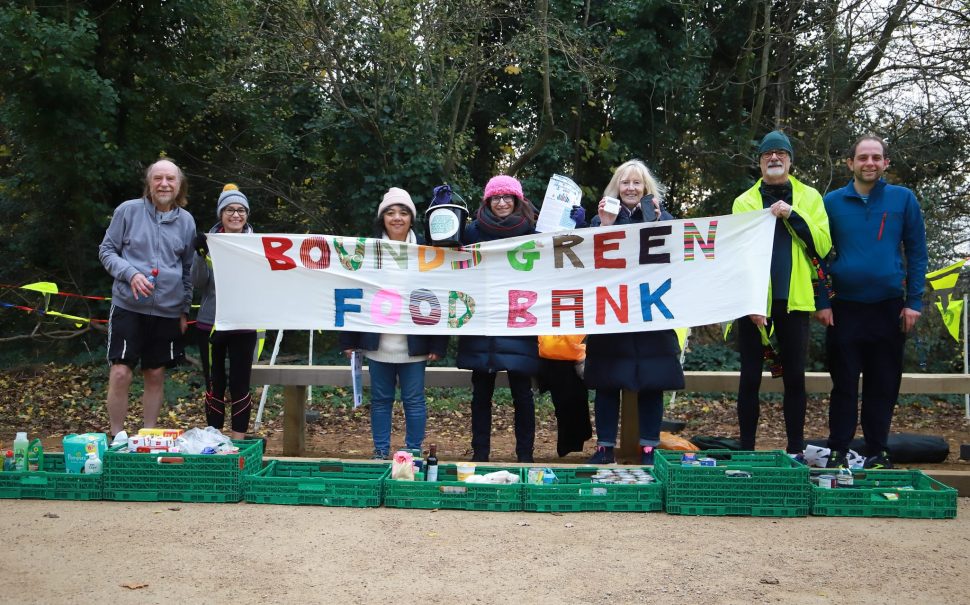 volunteers holding 'Bounds Green Foodbank' sign