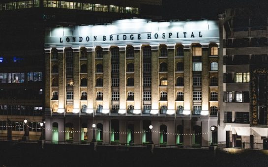 London Bridge Hospital illuminated by lights at night.