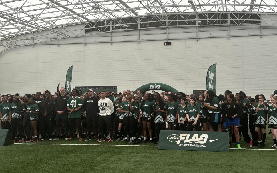 This picture is of NFL star Marcelino McCrary-Ball lining up for a photo with New York Jets' NFL Girls Flag League players.