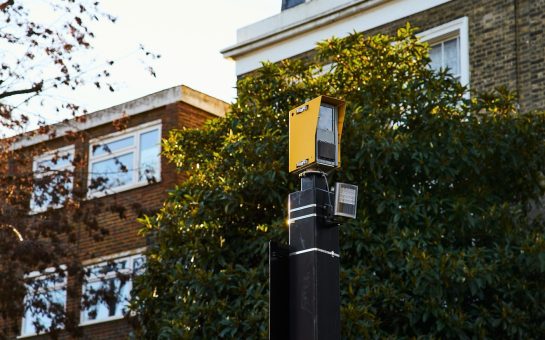 new security camera in front of buildings and trees