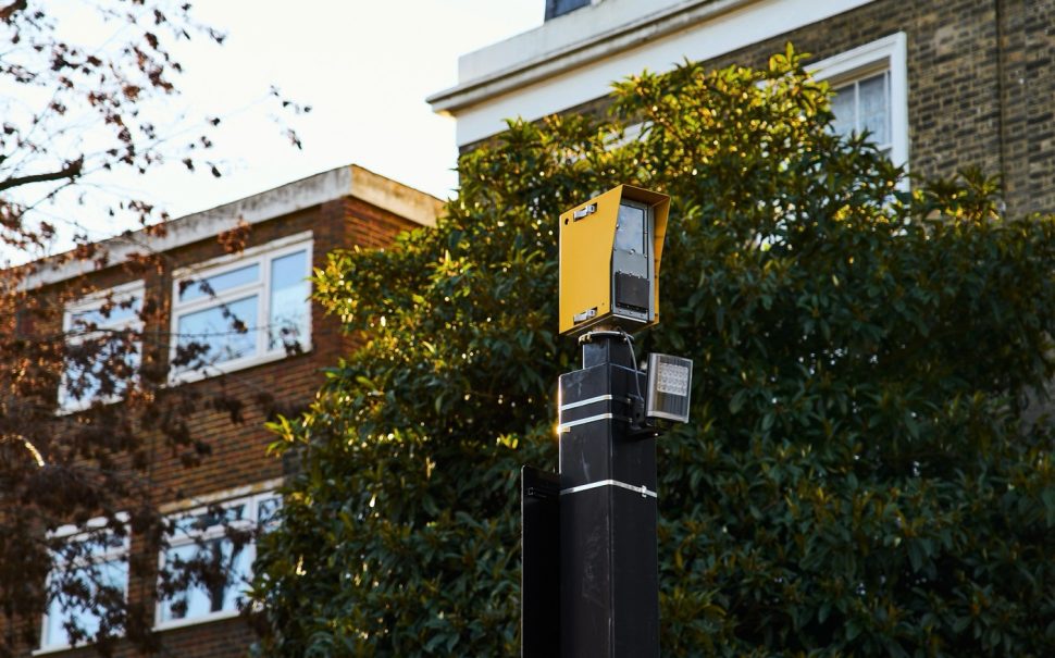 new security camera in front of buildings and trees