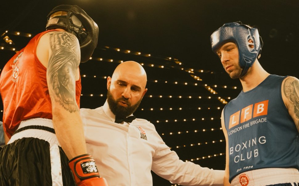 boxing umpire speaking to two boxers, one from the LFB