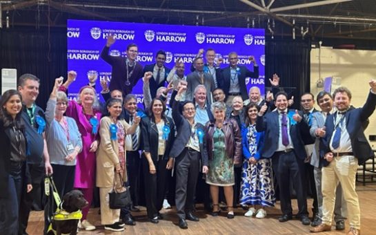 Celebrations from the Harrow Conservatives as they punch the air and smile to camera.