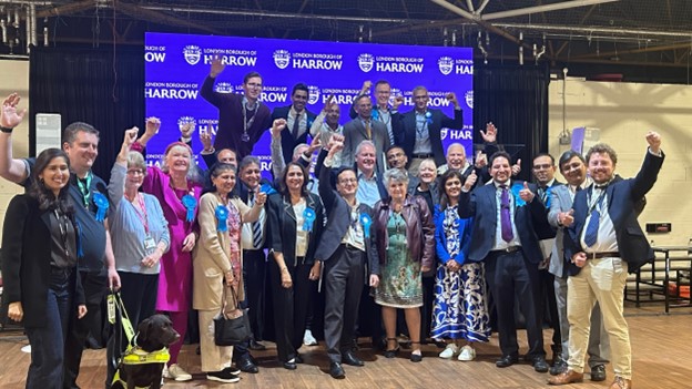 Celebrations from the Harrow Conservatives as they punch the air and smile to camera.