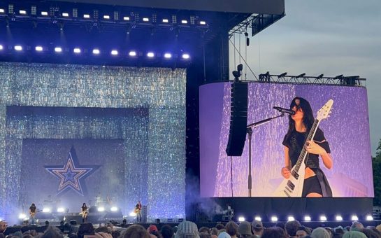 Woman playing the guitar on stage at Finsbury Park