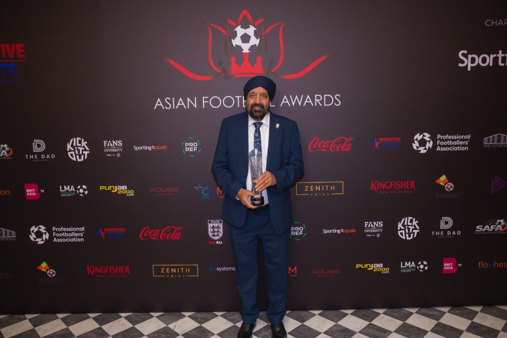 Micky Singh poses with his award