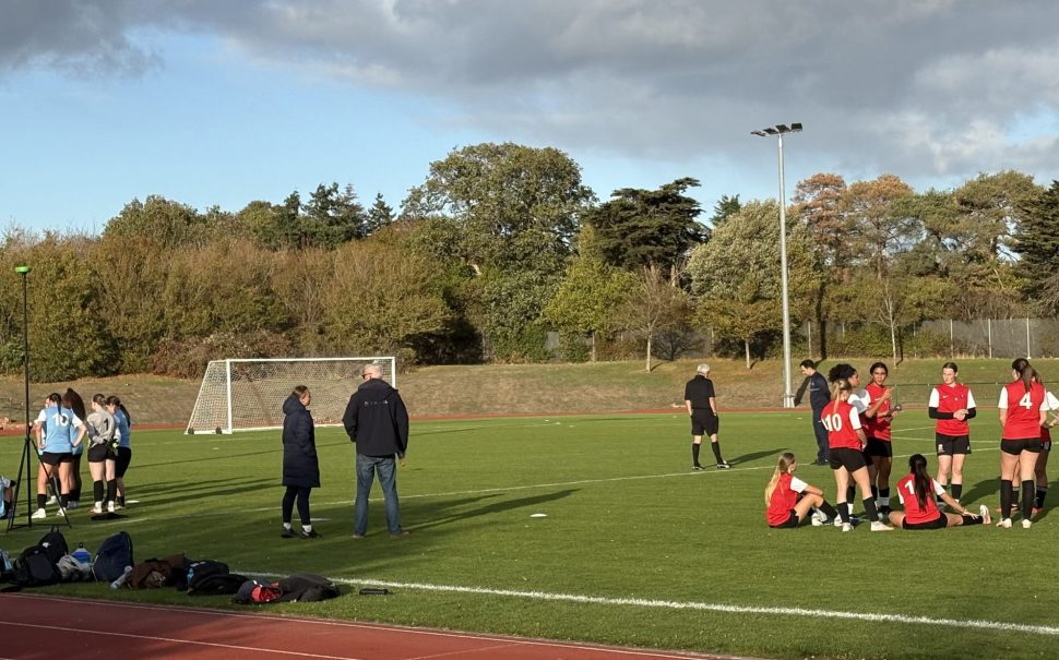 Half-time talk at women's football trial event