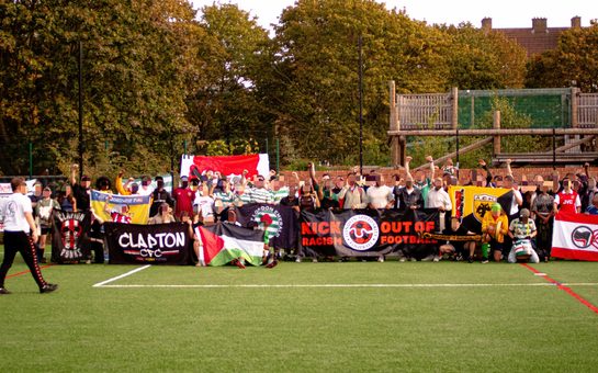 Football players holding up left-wing banners